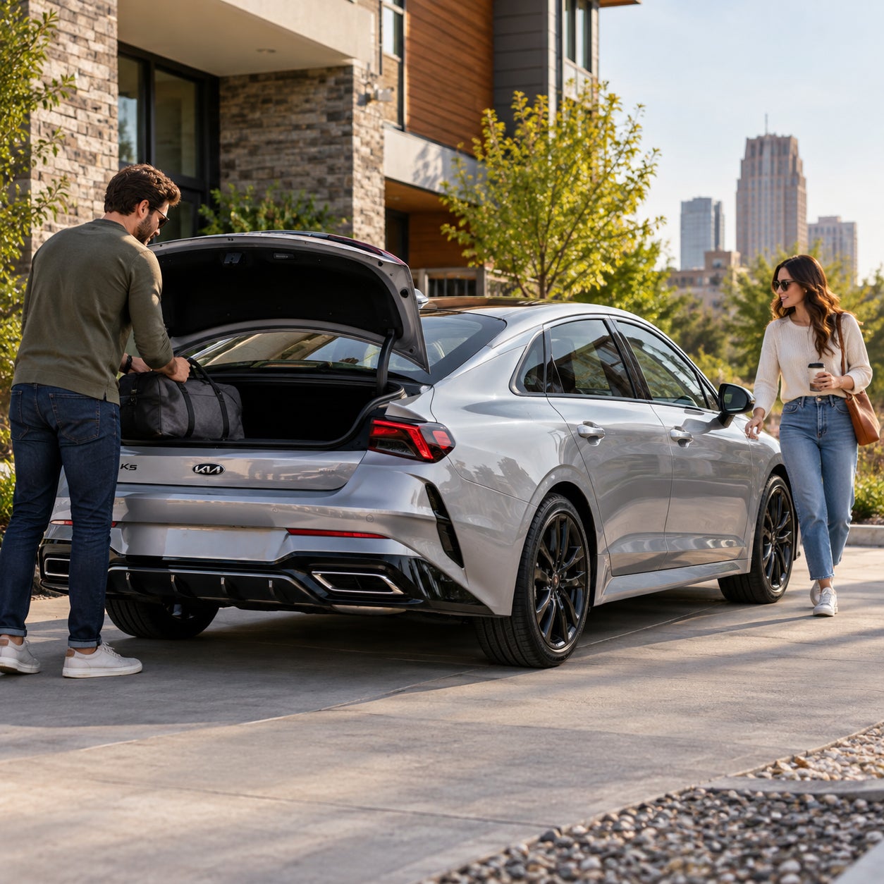 Kia K5 lifestyle scene with owners preparing for a drive