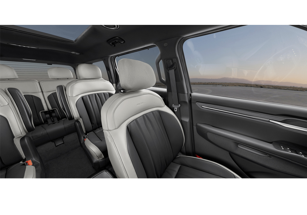 Kia 3rd row interior with colorful seats and passengers